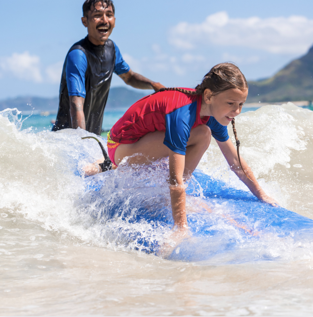 Teenager learning to surf on a private lesson during a luxury family vacation in Costa Rica